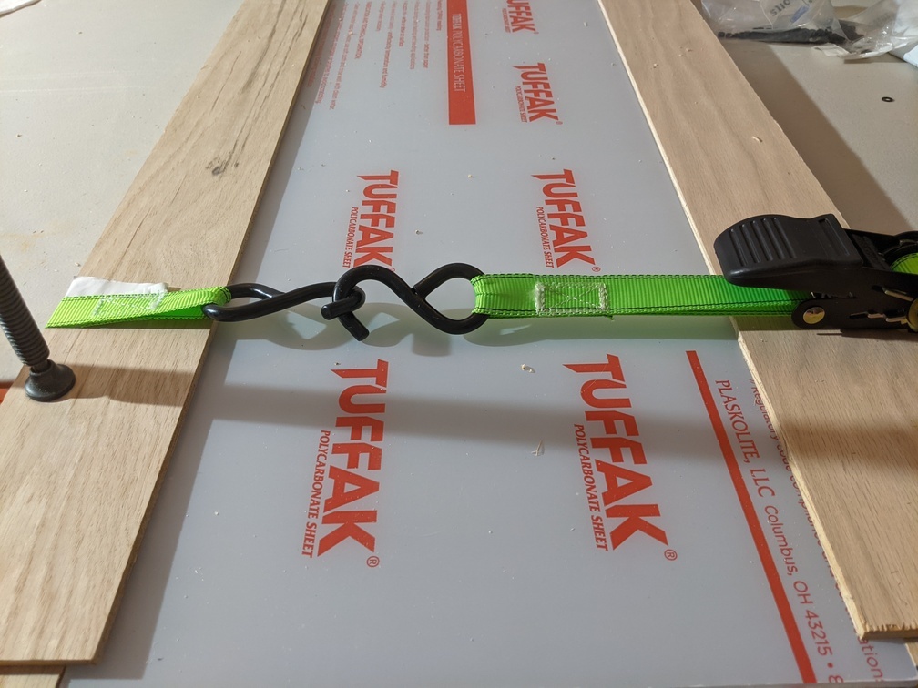 Using ratchet strap to assemble door